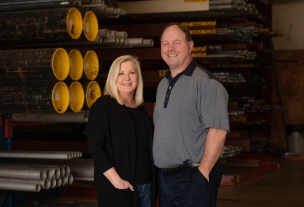 owners lisa waldrop and chris latimer posing in warehouse
